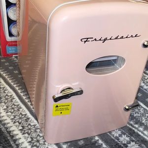 Pink mini fridge for makeup or snacks or drinks.